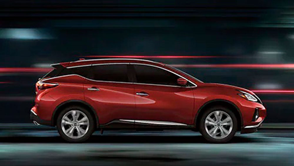 2023 Nissan Murano shown in profile driving down a street at night illustrating performance. | Marshall Nissan in Salina KS